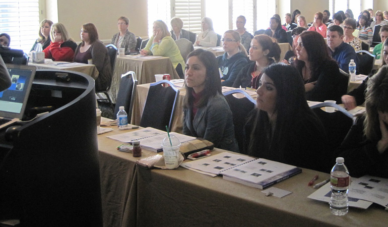 People sitting listening to a speaker.